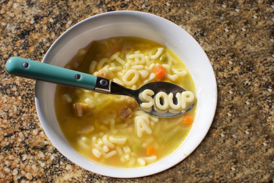 bowl of alphabet soup with the word soup spelled out on spoon