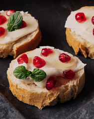 bread with cream cheese and pomegranate