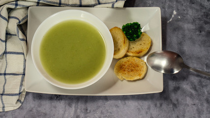broccoli soup puree with croutons on a stone background. selective focus