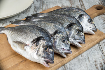 quattro orate su tagliere legno