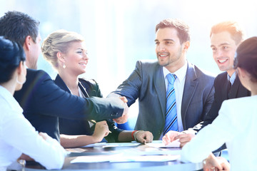 Two business colleagues shaking hands during meeting