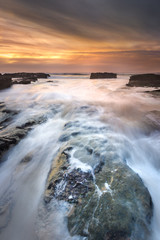 Sunset with high tide on isolated beach