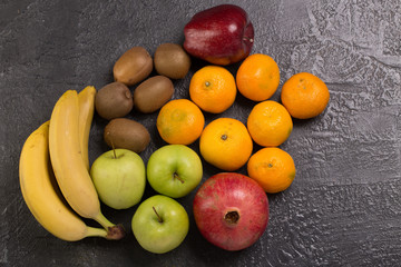 Fresh fruits on black texture background