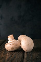 Detail of champignons on old wooden board