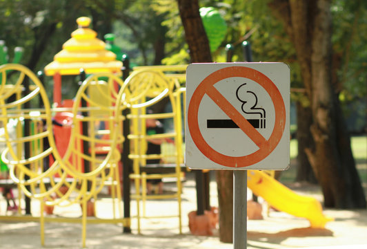 No smoking sign near children's playground in public park