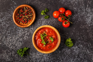 Tomato sauce with garlic and parsley in a wooden bowl.