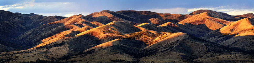 Panorama Scene of Mountains with Golden Sunlight on Them