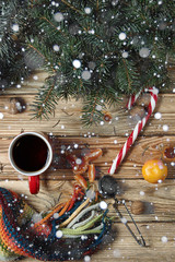 Xmas still-life with snow. Cozy and cute Christmas still life. Cup, scarf and sweets to keep warm...