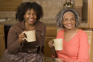 Senior woman having coffee with her daughter.