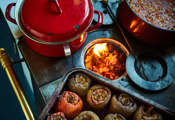 stuffed peppers over an old coal kitchen full of fire and other stews