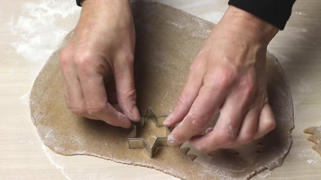 Baking Christmas cookies - Cutting out cookies from rolled out dough