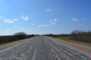 Fototapeta premium Beautiful spring rural landscape: road in the clouds, nature, countryside 