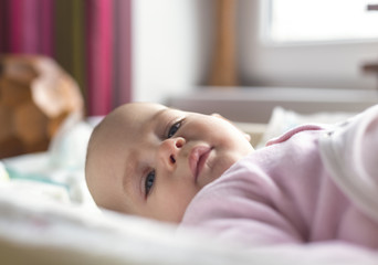 Portrait of a smiling baby laying