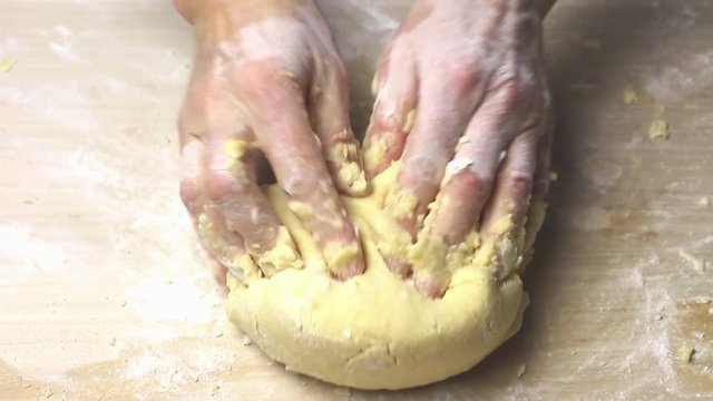 Knead the dough on a wooden board sprinkled with flour