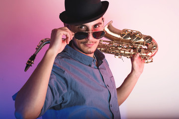 saxophonist holding saxophone 
