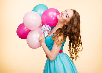 Woman with colorful balloons and lollipop