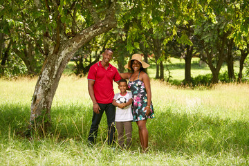 Fototapeta premium Mother Father And Child Smiling At Camera With Football