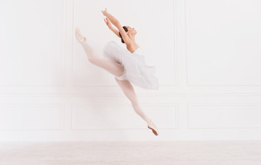Tender ballerina jumping over white background - obrazy, fototapety, plakaty