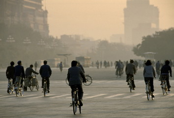 Chinese people using traditional bicycles for commuting around Tiananmen Square in Peking now Beijing, China in the 1980s