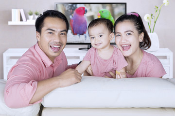 Obraz premium Happy family sitting in living room