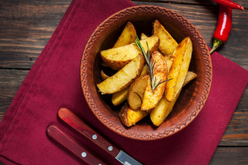 bowl of roasted potatoes with rosemary and tomatoes