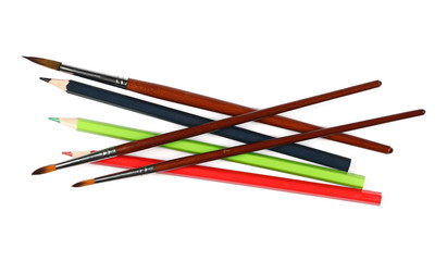 brushes painting and color pencils isolated on white