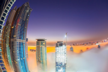 Fototapeta premium Dubai Marina is covered by early morning fog in Dubai, United Arab Emirates