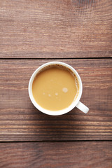 Cup of coffee on a brown wooden table