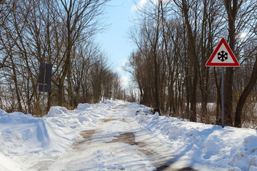 road with snow and traffic sign