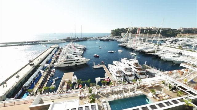 World Fair MYS Monaco Yacht Show, Port Hercules, luxury megayachts, many shuttles, taxi boat, presentations, Journalists, boat traffic, Azur water, aerial view, mountains on background, perspective