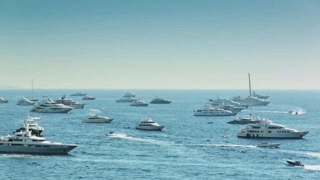 World Fair MYS Monaco Yacht Show, Port Hercules, luxury megayachts, many shuttles, taxi boat, presentations, Journalists, boat traffic, Azur water, aerial view, mountains on background, perspective
