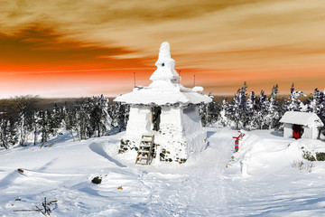 Snow-covered Buddhist stupa on a mountaintop