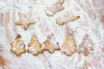 Background of christmas cookies in star, shooting star and christmas tree shapes.