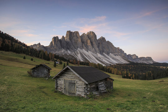 The early morning light illuminates Malga Zannes and the Odle in background, Funes Valley, South Tyrol, Dolomites
