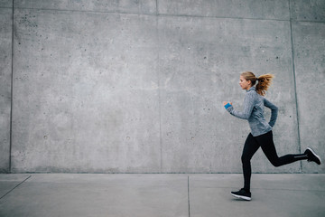 Healthy young woman running outdoors