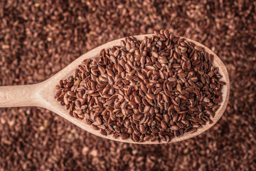 Flax seeds linseed on wooden spoon