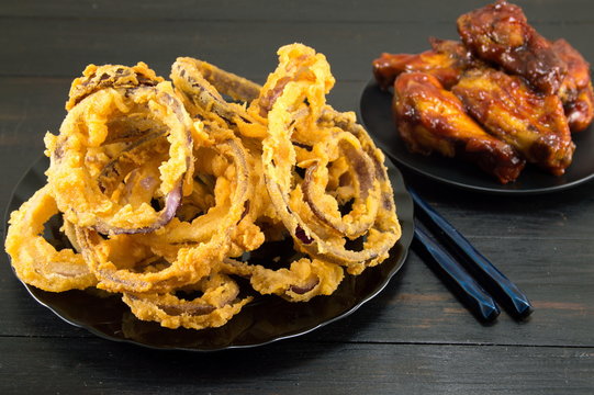 onion rings with chopsticks and bbq chicken wings