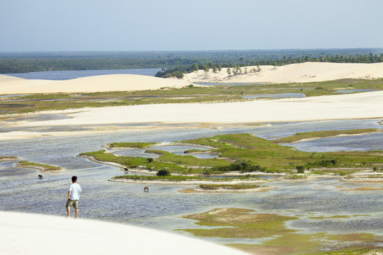 A man looking out from the Funil dune, Ceara, Brazil