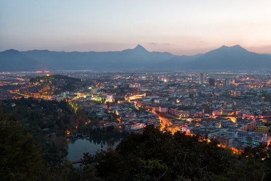 Cityscape of Lijiang, with Jade Spring Park, Lion Hill and surrounding mountains, Lijiang, Yunnan, China 