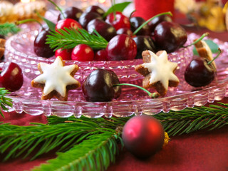 Christmas dessert - gingerbread, red berries cherries, cranberries and christmas tweeg