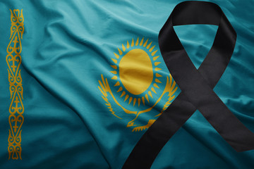 flag of kazakhstan with black mourning ribbon © luzitanija