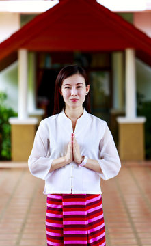 Woman making a Thai Wai salute in Lamphun