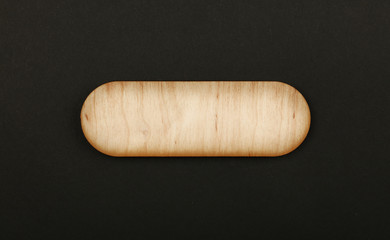 Figured shaped wooden sign on black background