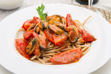 white dish with Pasta spaghetti , mussel and tomatoes