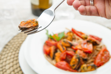 white dish with Pasta spaghetti , mussel and tomatoes