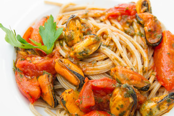 white dish with Pasta spaghetti , mussel and tomatoes