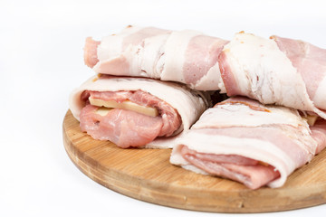 Stuffed pork chop with yellow cheese and rolled in bacon over wh