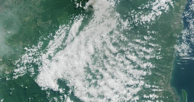 High-altitude overflight aerial of Mount Raung Volcano on the Indonesian island of Java. Clip loops and is reversible. Elements of this image furnished by USGS/NASA Landsat