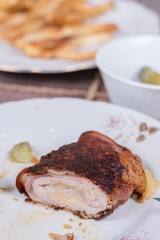 Slice of steak stuffed with yellow cheese rolled in bacon