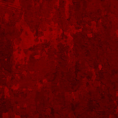 abstract red background or Christmas paper with bright center spotlight and black vignette border frame with vintage grunge